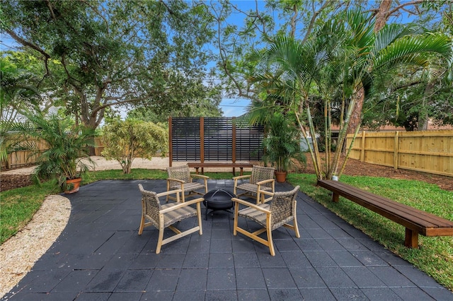 300 33rd Ave N, Saint Petersburg, FL 33704 - fenced backyard featuring a fire pit and a patio area
