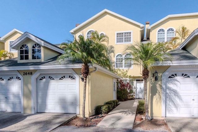2648 Sabal Springs Dr Unit 2, Clearwater, FL 33761 - view of front of property with a garage, stucco siding, and concrete driveway
