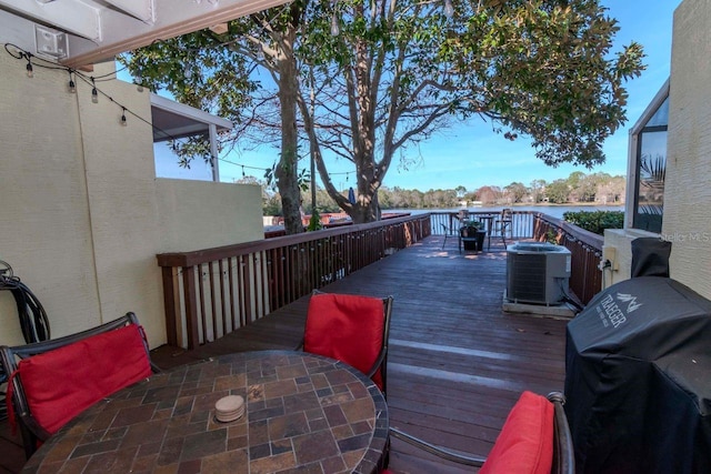 2648 Sabal Springs Dr Unit 2, Clearwater, FL 33761 - wooden terrace featuring central AC unit, outdoor dining space, and grilling area