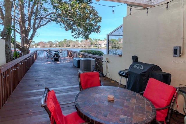2648 Sabal Springs Dr Unit 2, Clearwater, FL 33761 - wooden deck with outdoor dining area, central air condition unit, area for grilling, and a water view