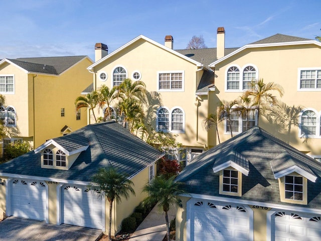 2648 Sabal Springs Dr Unit 2, Clearwater, FL 33761 - view of front facade with a garage, driveway, and stucco siding