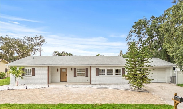 2554 Lake Ellen Cir, Tampa, FL 33618 - ranch-style house featuring driveway, brick siding, and a garage