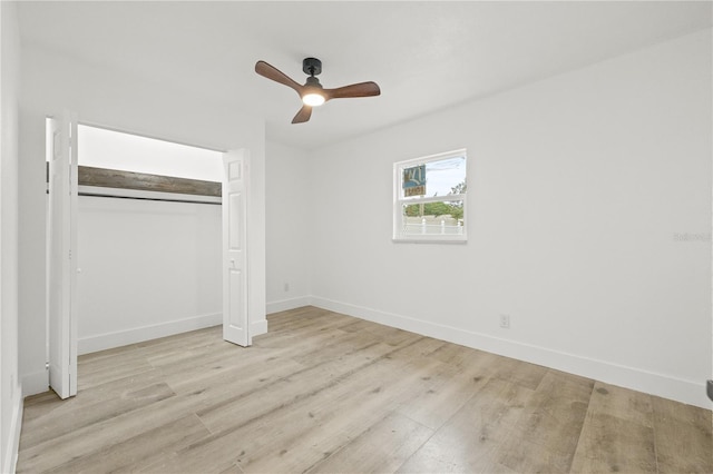 2554 Lake Ellen Cir, Tampa, FL 33618 - unfurnished bedroom featuring light wood finished floors, baseboards, a closet, and ceiling fan