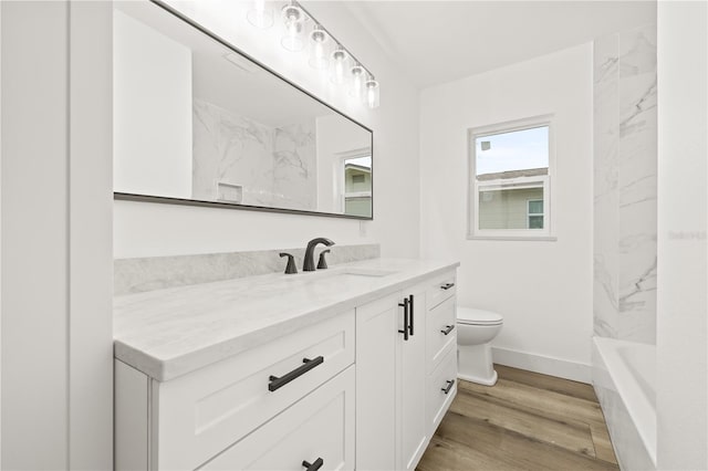 2554 Lake Ellen Cir, Tampa, FL 33618 - bathroom with vanity, toilet, wood finished floors, and baseboards