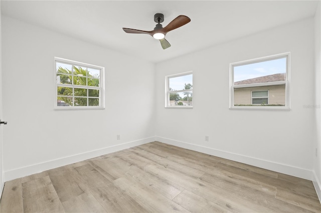 2554 Lake Ellen Cir, Tampa, FL 33618 - spare room featuring wood finished floors, baseboards, and a ceiling fan
