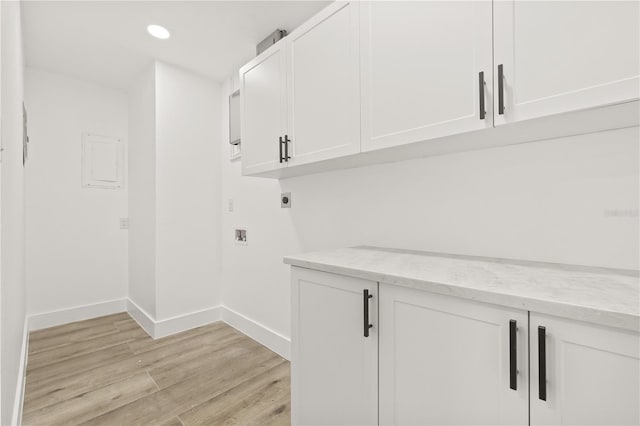 2554 Lake Ellen Cir, Tampa, FL 33618 - laundry room featuring electric dryer hookup, light wood-type flooring, cabinet space, recessed lighting, and baseboards