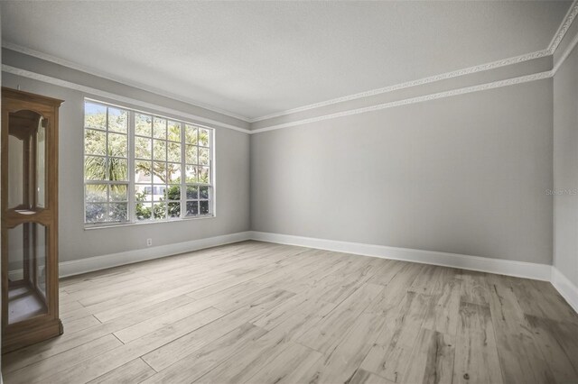 5160 Loquat Ct, Palm Harbor, FL 34685 - spare room featuring ornamental molding, light wood finished floors, and baseboards
