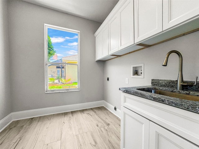 5160 Loquat Ct, Palm Harbor, FL 34685 - laundry room with washer hookup, cabinet space, hookup for an electric dryer, baseboards, and light wood-style floors
