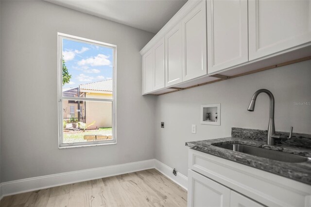 5160 Loquat Ct, Palm Harbor, FL 34685 - laundry area featuring hookup for a washing machine, cabinet space, baseboards, and hookup for an electric dryer