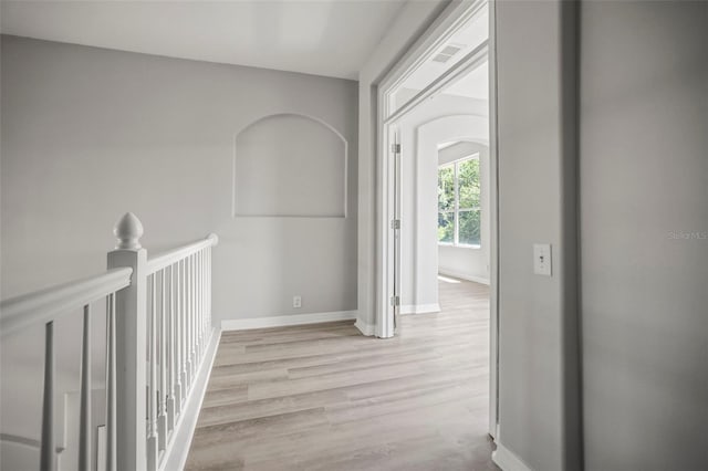 5160 Loquat Ct, Palm Harbor, FL 34685 - hall featuring baseboards, light wood finished floors, and an upstairs landing