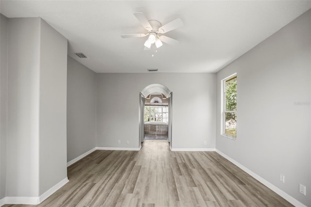 5160 Loquat Ct, Palm Harbor, FL 34685 - empty room with plenty of natural light, wood finished floors, and a ceiling fan