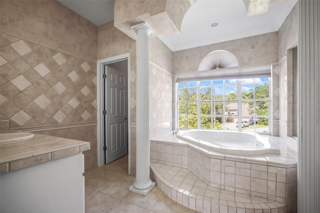 5160 Loquat Ct, Palm Harbor, FL 34685 - full bath with tile patterned flooring, vanity, a bath, ornate columns, and tile walls