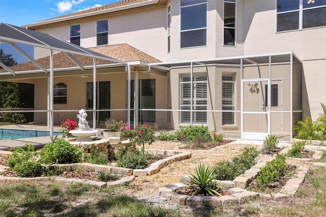 5160 Loquat Ct, Palm Harbor, FL 34685 - back of house with stucco siding, glass enclosure, a patio, roof with shingles, and an outdoor pool