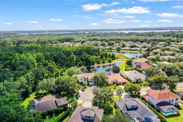 5160 Loquat Ct, Palm Harbor, FL 34685 - aerial perspective of suburban area featuring a nearby body of water and a heavily wooded area