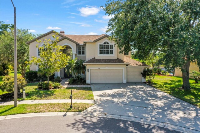 5160 Loquat Ct, Palm Harbor, FL 34685 - traditional-style home with concrete driveway, a front yard, stucco siding, an attached garage, and a chimney