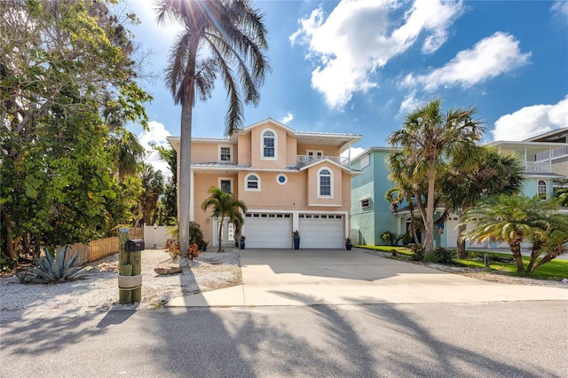 405 8th Ave N, Tierra Verde, FL 33715 - mediterranean / spanish-style house with stucco siding, a garage, and concrete driveway
