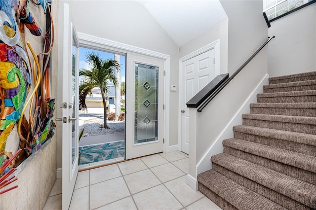 405 8th Ave N, Tierra Verde, FL 33715 - foyer entrance featuring lofted ceiling, stairs, and light tile patterned floors