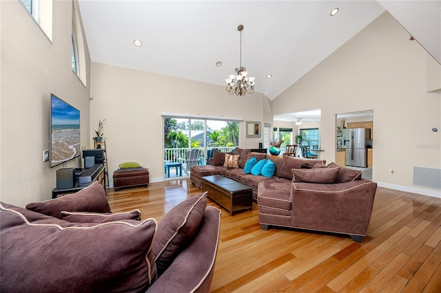 405 8th Ave N, Tierra Verde, FL 33715 - living room with high vaulted ceiling, a chandelier, light wood-style flooring, baseboards, and recessed lighting