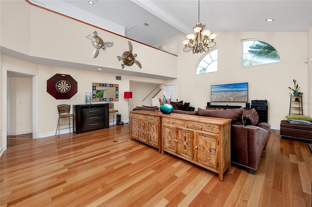 405 8th Ave N, Tierra Verde, FL 33715 - living room featuring light wood-style flooring, stairs, beam ceiling, high vaulted ceiling, and a chandelier