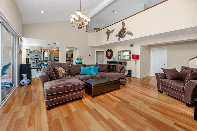 405 8th Ave N, Tierra Verde, FL 33715 - living area with high vaulted ceiling, a chandelier, light wood-style floors, recessed lighting, and baseboards