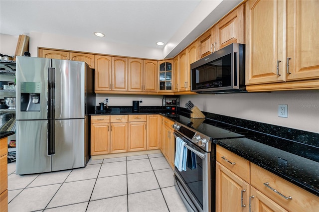 405 8th Ave N, Tierra Verde, FL 33715 - kitchen featuring stainless steel appliances, dark stone countertops, light tile patterned floors, glass insert cabinets, and recessed lighting