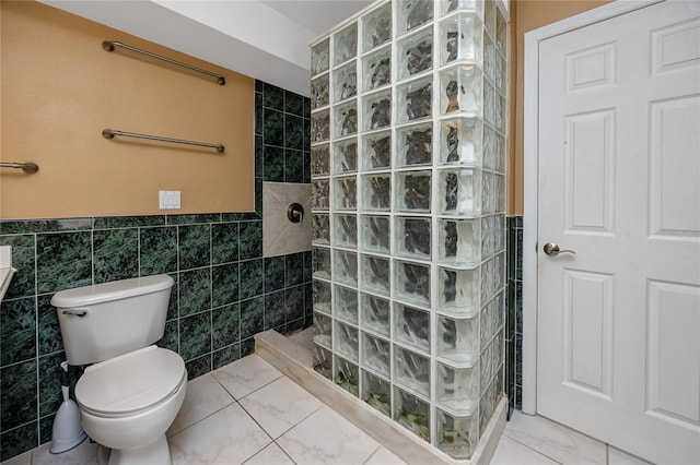 405 8th Ave N, Tierra Verde, FL 33715 - full bathroom with tile walls, a walk in shower, toilet, a wainscoted wall, and tile patterned flooring