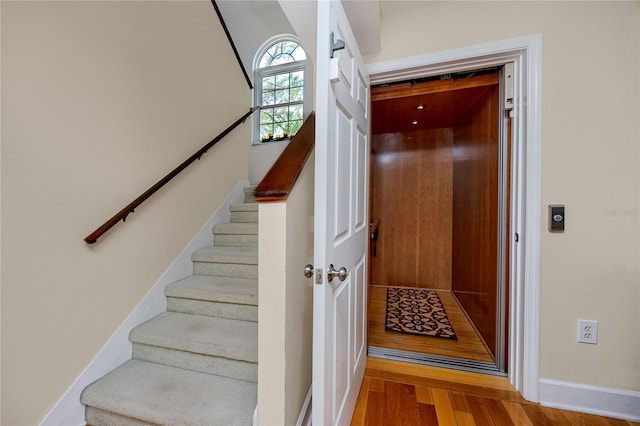 405 8th Ave N, Tierra Verde, FL 33715 - stairway with wood finished floors, elevator, and baseboards