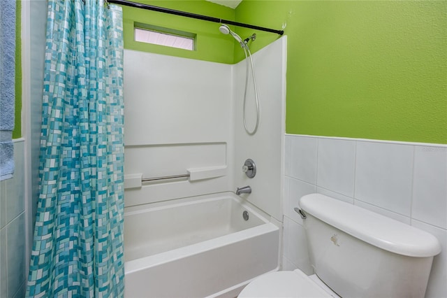 405 8th Ave N, Tierra Verde, FL 33715 - full bathroom with shower / bathtub combination with curtain, toilet, tile walls, and wainscoting