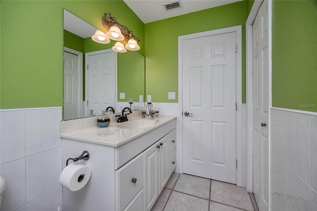 405 8th Ave N, Tierra Verde, FL 33715 - bathroom featuring wainscoting, vanity, and tile patterned floors