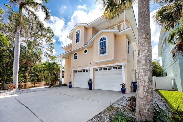 405 8th Ave N, Tierra Verde, FL 33715 - view of side of home featuring stucco siding, an attached garage, and concrete driveway