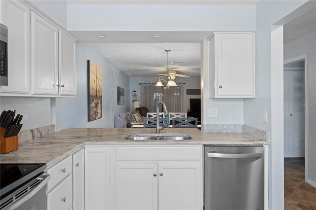 340 Causeway Blvd Unit 104, Dunedin, FL 34698 - kitchen featuring stainless steel appliances, a sink, a ceiling fan, white cabinetry, and recessed lighting