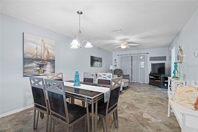 340 Causeway Blvd Unit 104, Dunedin, FL 34698 - dining space with a chandelier and a ceiling fan