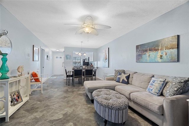 340 Causeway Blvd Unit 104, Dunedin, FL 34698 - living room featuring ceiling fan, a textured ceiling, and baseboards