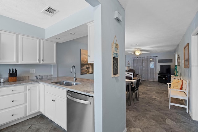 340 Causeway Blvd Unit 104, Dunedin, FL 34698 - kitchen with dishwasher, a sink, ceiling fan, light stone counters, and white cabinets