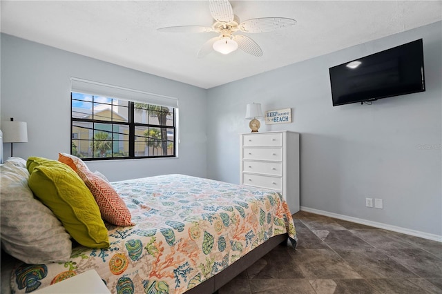 340 Causeway Blvd Unit 104, Dunedin, FL 34698 - bedroom with baseboards, a ceiling fan, and stone finish flooring