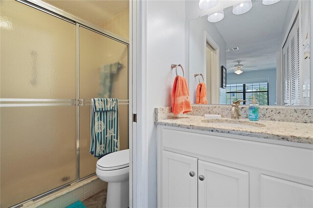340 Causeway Blvd Unit 104, Dunedin, FL 34698 - full bath featuring a shower stall, toilet, vanity, ceiling fan, and tile patterned floors
