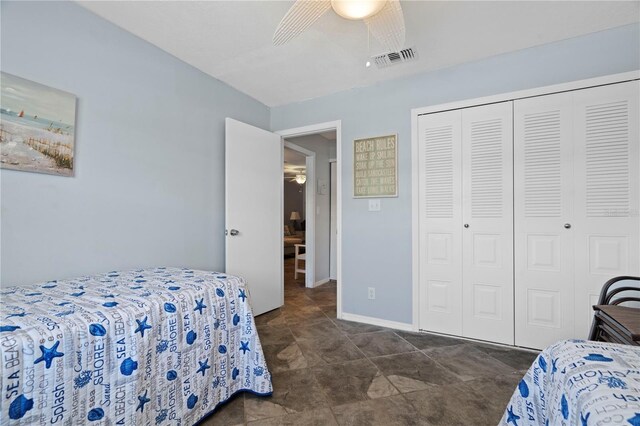 340 Causeway Blvd Unit 104, Dunedin, FL 34698 - bedroom featuring a closet, a ceiling fan, and baseboards