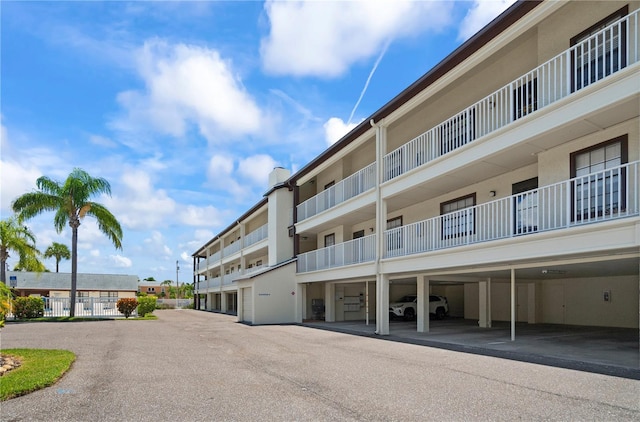 340 Causeway Blvd Unit 104, Dunedin, FL 34698 - view of apartment building / complex featuring covered parking