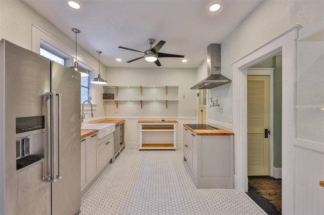 1825 2nd St S, Saint Petersburg, FL 33705 - kitchen featuring wooden counters, appliances with stainless steel finishes, wall chimney exhaust hood, a sink, and ceiling fan