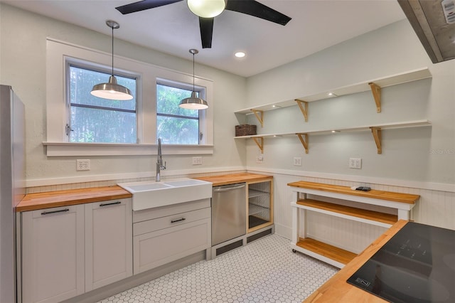 1825 2nd St S, Saint Petersburg, FL 33705 - kitchen with butcher block counters, a sink, open shelves, ceiling fan, and hanging light fixtures