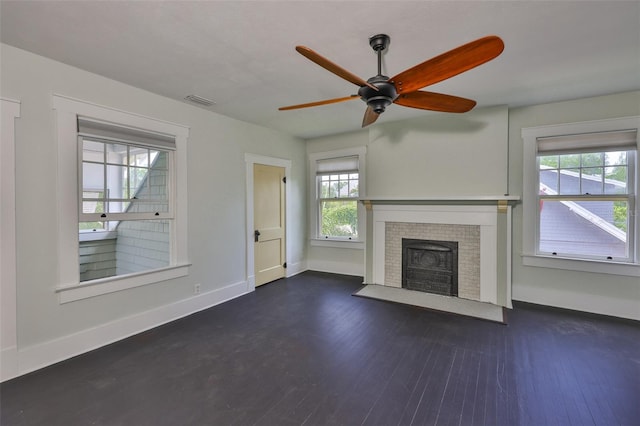 1825 2nd St S, Saint Petersburg, FL 33705 - unfurnished living room featuring dark wood-style flooring, baseboards, a fireplace with flush hearth, and ceiling fan