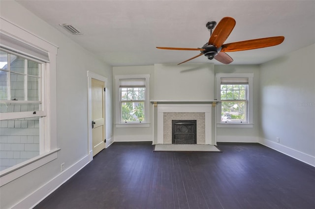 1825 2nd St S, Saint Petersburg, FL 33705 - unfurnished living room featuring dark wood finished floors, a fireplace, ceiling fan, and baseboards