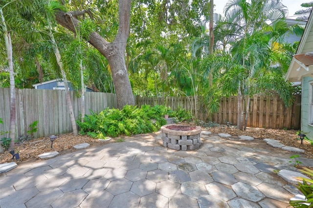 1825 2nd St S, Saint Petersburg, FL 33705 - fenced backyard with a patio area and a fire pit