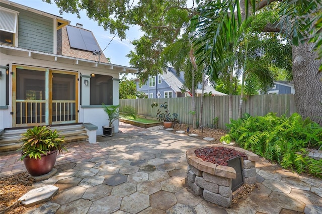 1825 2nd St S, Saint Petersburg, FL 33705 - fenced backyard with entry steps, a patio, and a sunroom