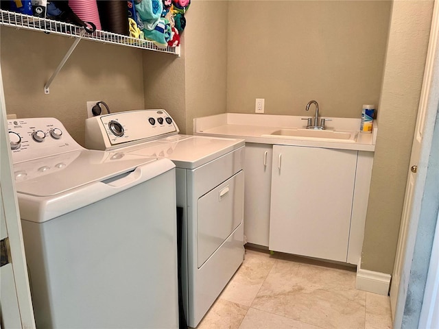 1180 Gulf Blvd Unit 306, Clearwater, FL 33767 - washroom with separate washer and dryer, cabinet space, and light tile patterned floors