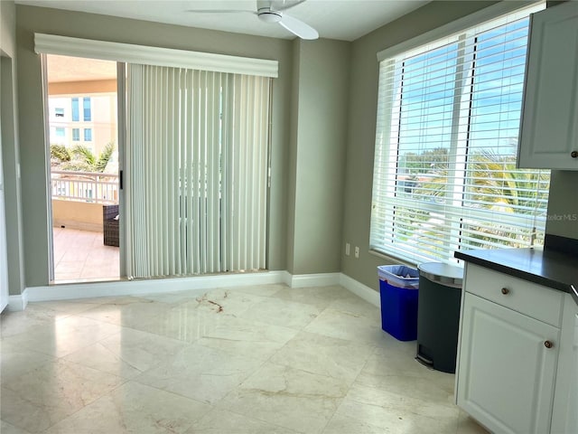 1180 Gulf Blvd Unit 306, Clearwater, FL 33767 - unfurnished room with baseboards, healthy amount of natural light, and a ceiling fan