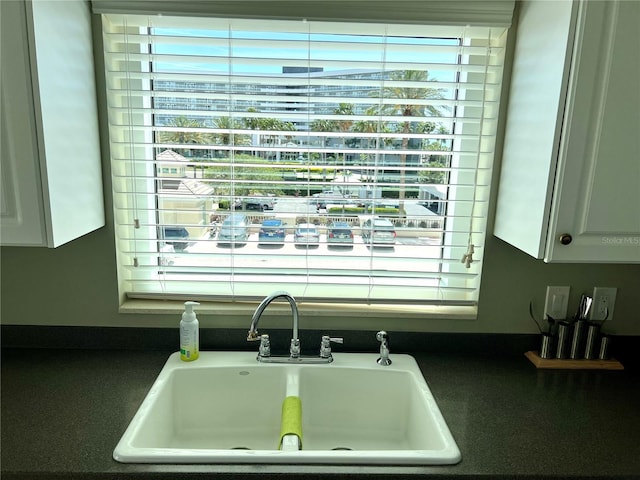 1180 Gulf Blvd Unit 306, Clearwater, FL 33767 - kitchen view of a sink and dark countertops