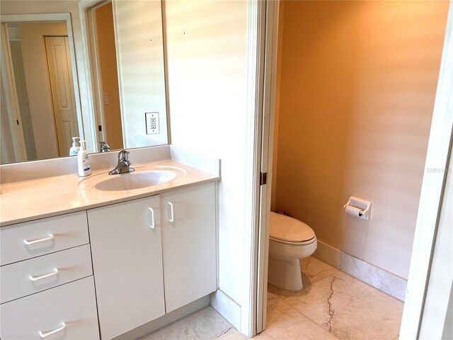 1180 Gulf Blvd Unit 306, Clearwater, FL 33767 - bathroom with vanity, toilet, and baseboards