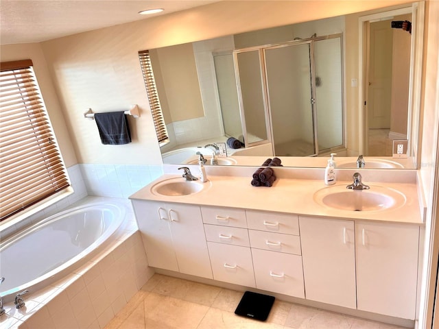 1180 Gulf Blvd Unit 306, Clearwater, FL 33767 - bathroom with a garden tub, double vanity, a stall shower, tile patterned flooring, and plenty of natural light