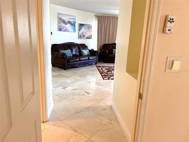 1180 Gulf Blvd Unit 306, Clearwater, FL 33767 - hallway featuring light marble finish floors and baseboards